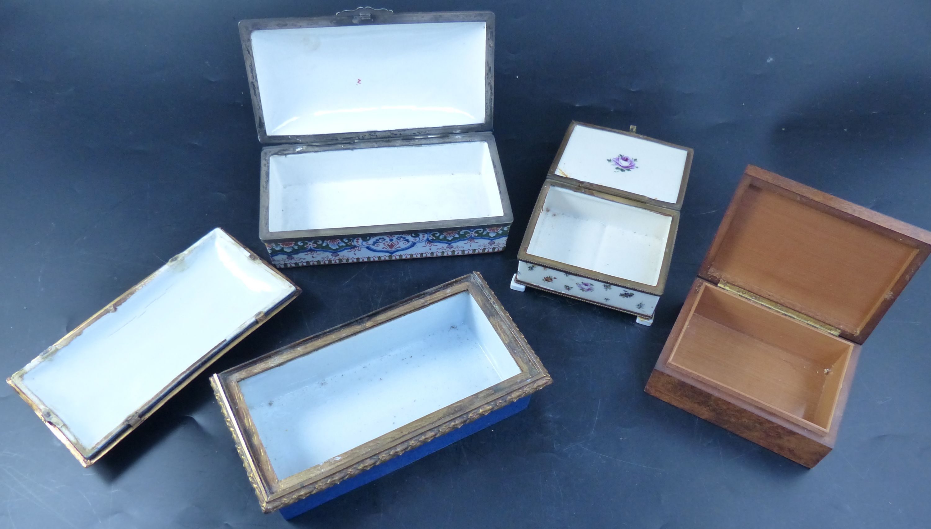 A burr wood cigarette box and three ormolu mounted ceramic caskets, largest 20cm